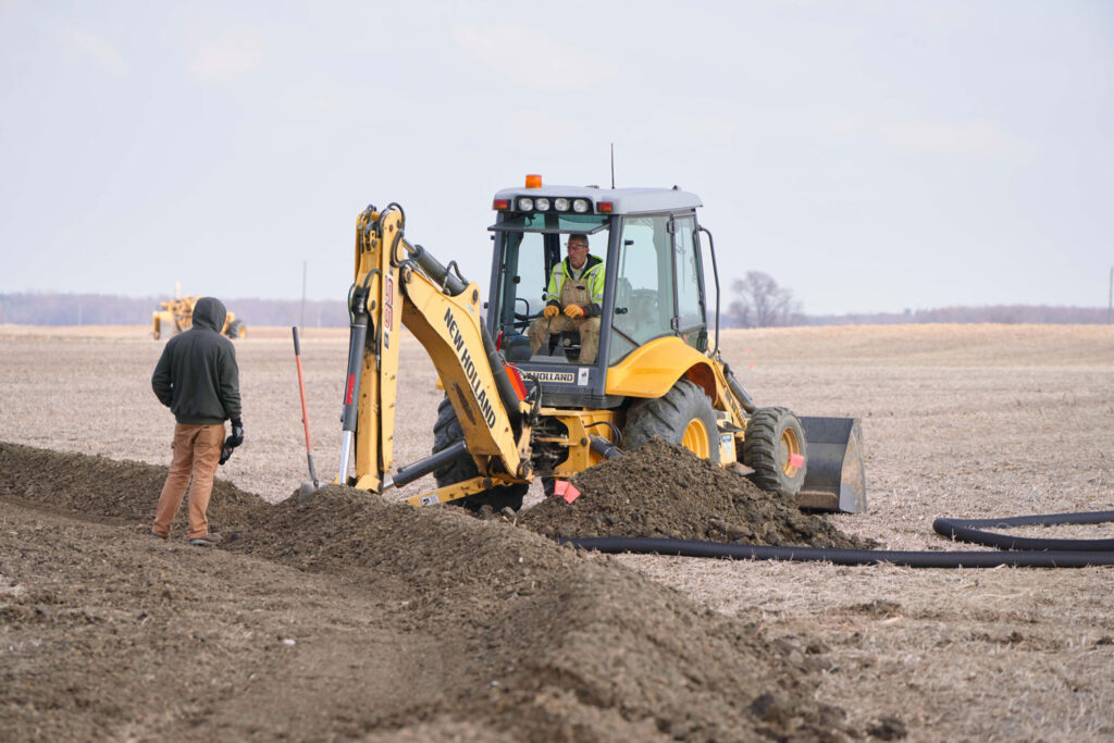 Men installing drainage pipe