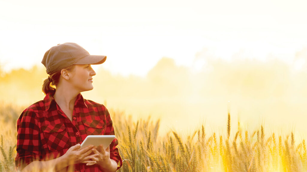 Woman in field with tablet