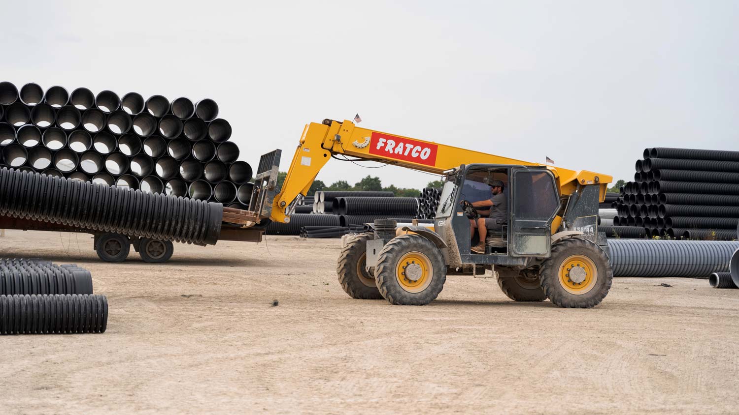 Forklift vehicle picking up Fratco pipe