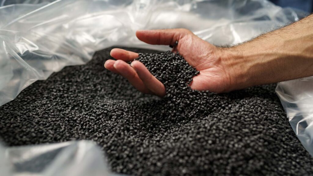 hand reaching into recycled resin